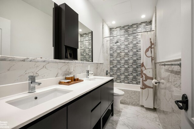 full bathroom with vanity, toilet, shower / tub combo, and tile walls