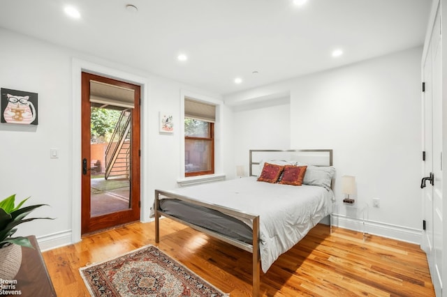 bedroom with access to outside and light hardwood / wood-style floors