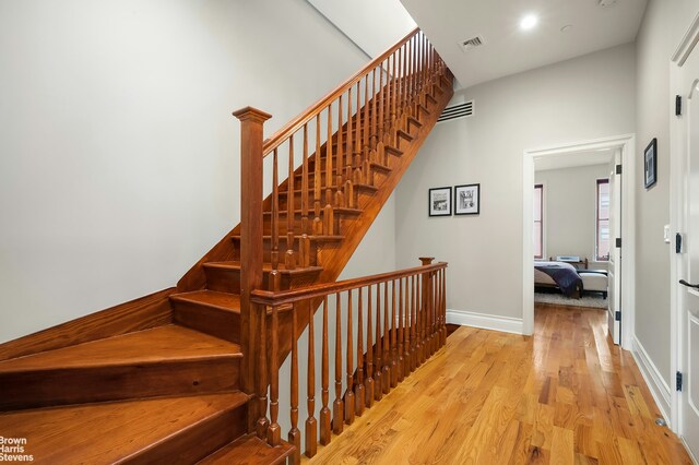 staircase featuring wood-type flooring