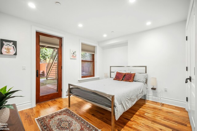 bedroom featuring access to exterior and light hardwood / wood-style floors