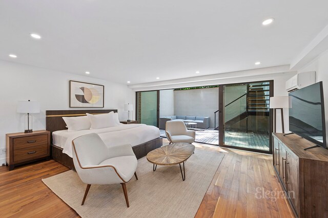 bedroom featuring access to exterior and light hardwood / wood-style floors