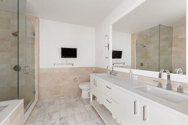 408 E 79th St Unit 7-Ad, New York City, NY 10075 - full bath with tile walls, a shower stall, double vanity, toilet, and a wainscoted wall