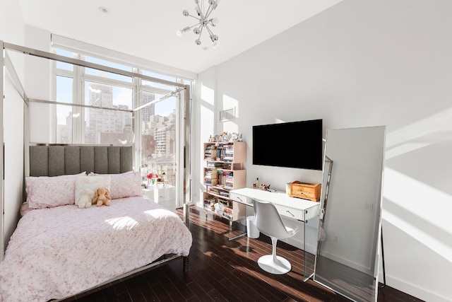 bedroom featuring dark hardwood / wood-style floors and a wall of windows