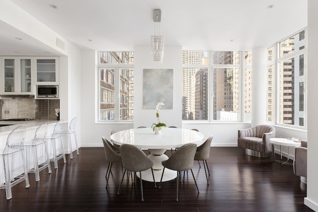 dining area featuring dark wood-type flooring