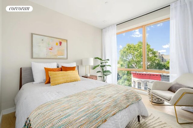 bedroom with visible vents and wood finished floors