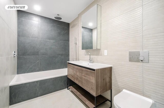 bathroom featuring vanity, visible vents, tile patterned flooring, tile walls, and toilet