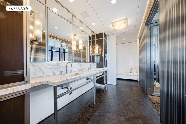 bathroom with double vanity, a sink, and decorative backsplash