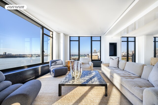 living room with expansive windows and a water view