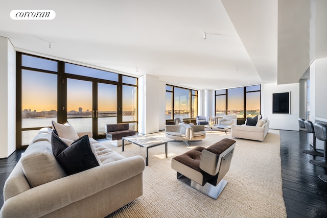 living room with wood finished floors, visible vents, french doors, expansive windows, and rail lighting