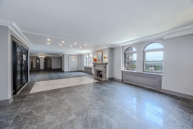 unfurnished living room featuring radiator, marble finish floor, a fireplace, and arched walkways