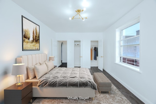 bedroom featuring a closet, dark wood finished floors, and baseboards