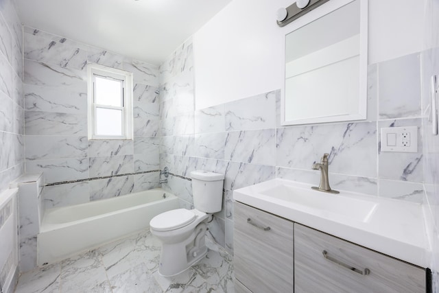 bathroom featuring toilet, marble finish floor, bathtub / shower combination, vanity, and tile walls