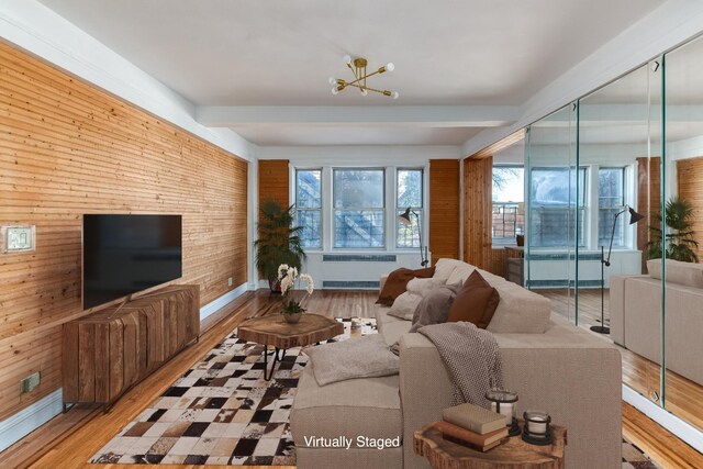 living room featuring hardwood / wood-style flooring, radiator heating unit, and wooden walls