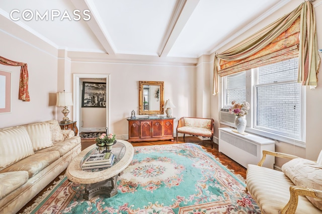 1060 Park Ave Unit 3B, New York City, NY 10128 - living area featuring beamed ceiling, radiator heating unit, ornamental molding, and wood finished floors