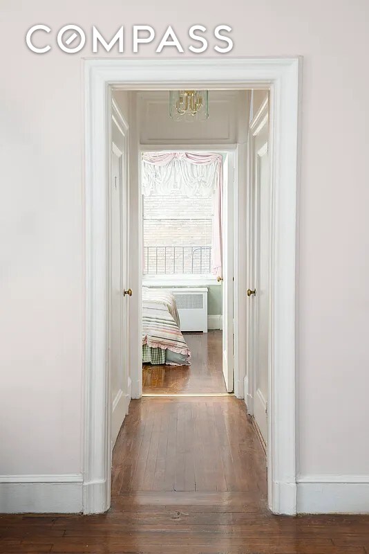 hall with radiator and dark hardwood / wood-style floors