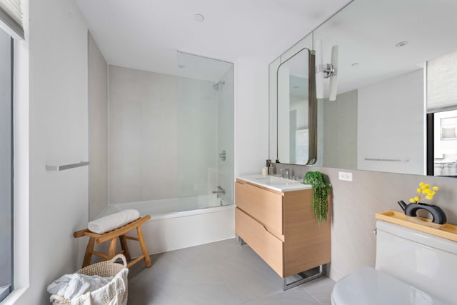 full bathroom featuring shower / bath combination with glass door, vanity, and toilet