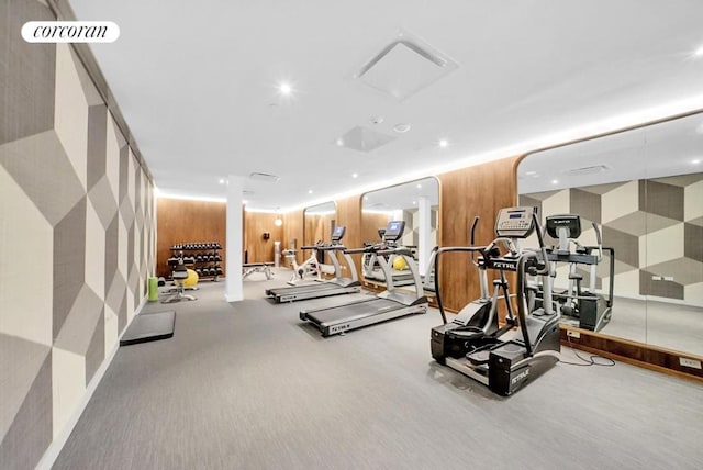 gym with wood walls, visible vents, and recessed lighting