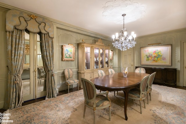 dining area with a notable chandelier and crown molding