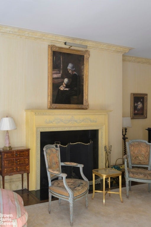 living area with crown molding