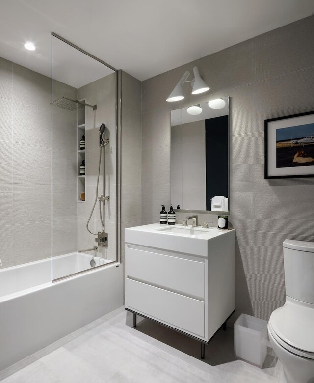 full bathroom with tiled shower / bath combo, vanity, and toilet