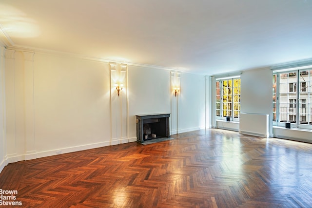 unfurnished living room featuring dark parquet floors and ornamental molding