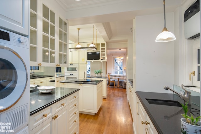 kitchen featuring sink, white cabinetry, ornamental molding, pendant lighting, and light hardwood / wood-style floors