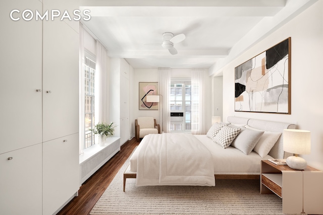 bedroom with dark wood-type flooring, radiator, beam ceiling, and a ceiling fan