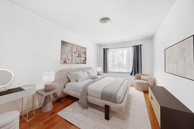 bedroom with hardwood / wood-style floors