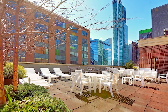 view of patio / terrace featuring outdoor dining area and a city view