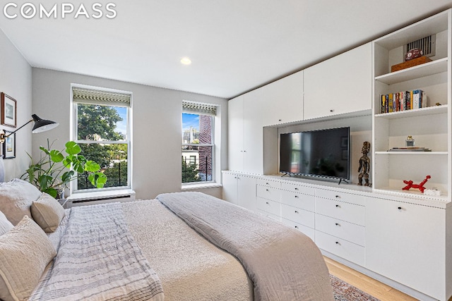 bedroom with light hardwood / wood-style flooring