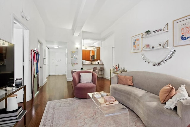 living room with beamed ceiling and dark hardwood / wood-style flooring