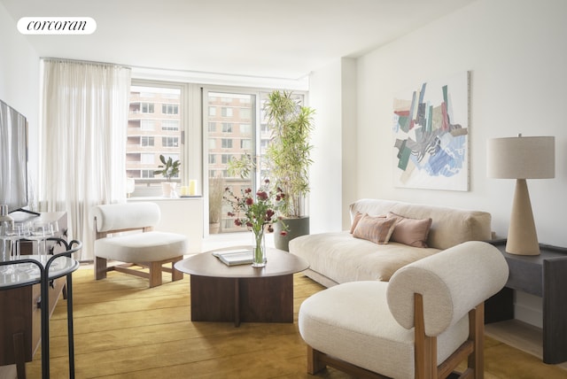 living area featuring visible vents and wood finished floors