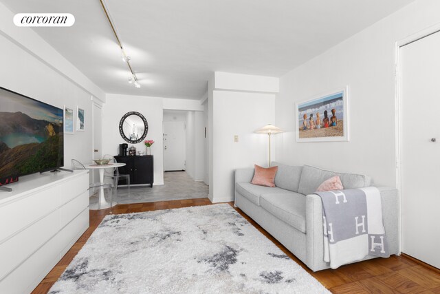 living room featuring parquet flooring and track lighting