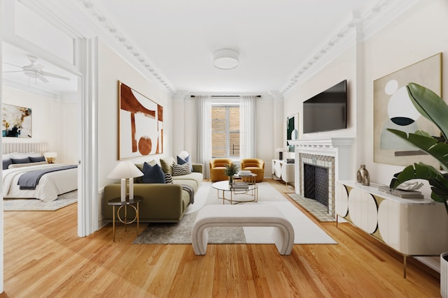 living room featuring hardwood / wood-style floors, crown molding, a tile fireplace, and ceiling fan