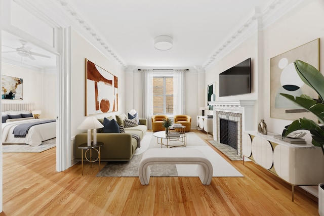 sitting room featuring ceiling fan, a fireplace, ornamental molding, and wood finished floors