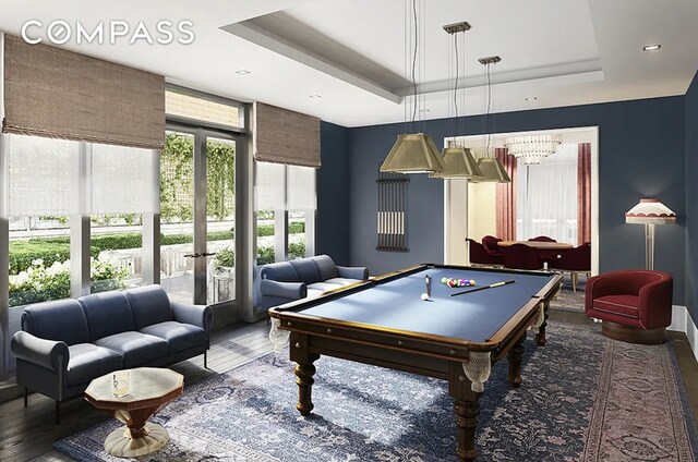 playroom featuring french doors, billiards, a tray ceiling, and dark hardwood / wood-style floors