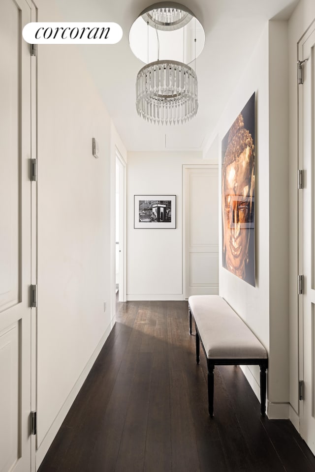 hall featuring dark wood finished floors and baseboards