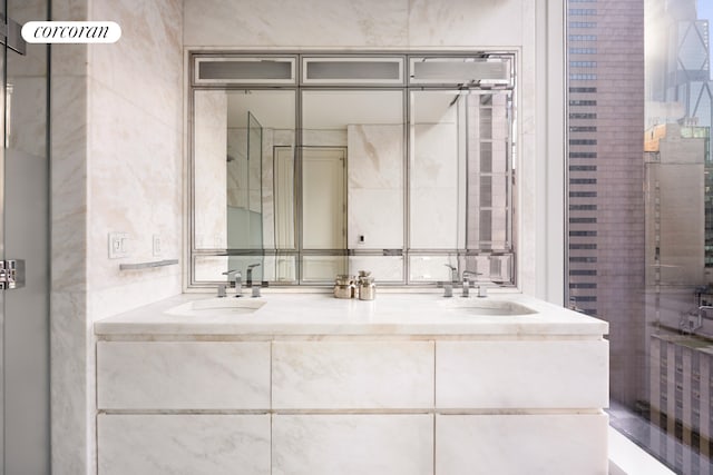 full bathroom with a sink and double vanity