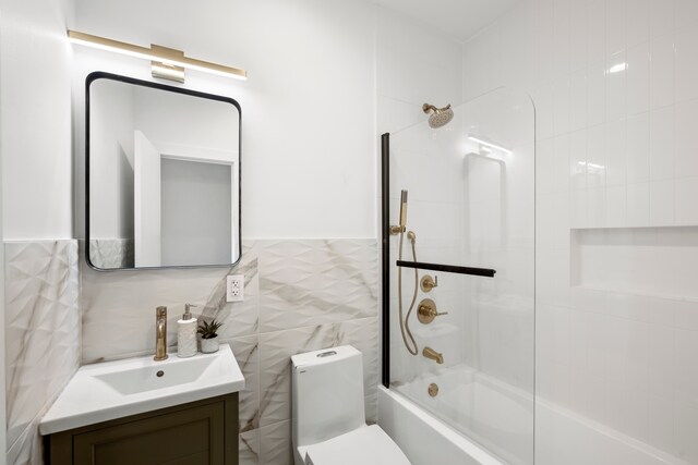 125 Beadel St, New York City, NY 11222 - bathroom featuring bathtub / shower combination, tile walls, vanity, and toilet