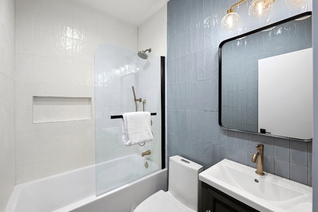 full bathroom with toilet, tile walls, vanity, shower / bath combination, and backsplash