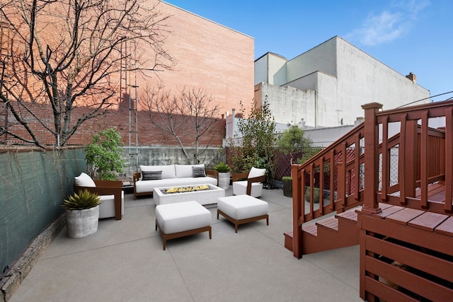 view of patio / terrace featuring an outdoor living space with a fire pit