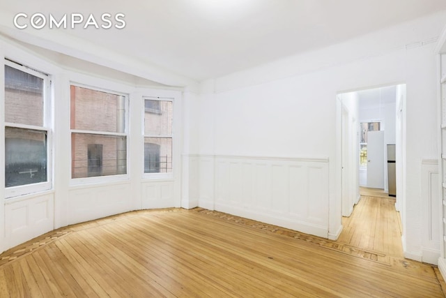 unfurnished room with wood-type flooring