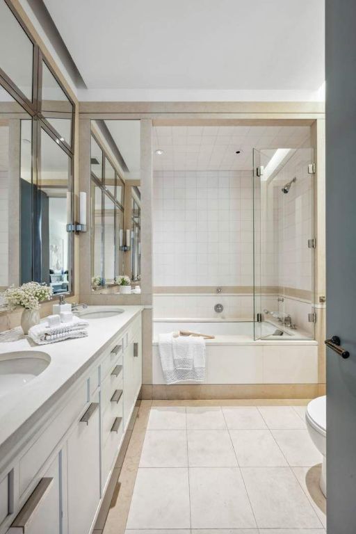 full bathroom featuring tile patterned flooring, vanity, combined bath / shower with glass door, and toilet