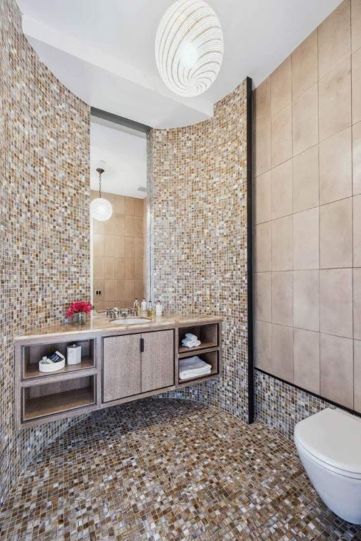 bathroom with tile walls, vanity, and toilet