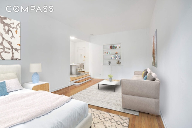 bedroom featuring wood finished floors and baseboards