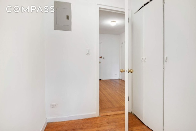 hall featuring electric panel and light hardwood / wood-style flooring