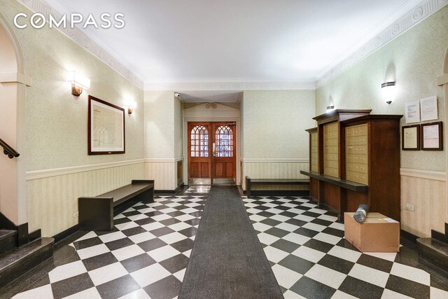 entrance foyer with ornamental molding and french doors