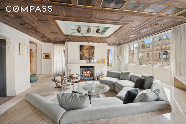 living room with coffered ceiling and ornamental molding