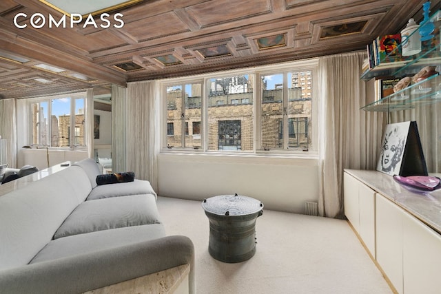 sitting room featuring coffered ceiling and carpet flooring