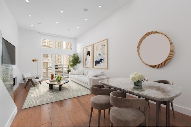 living room with a high ceiling and wood-type flooring